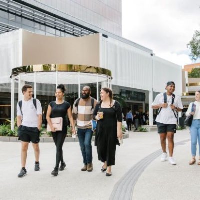 A group of students walks on the St Lucia campus